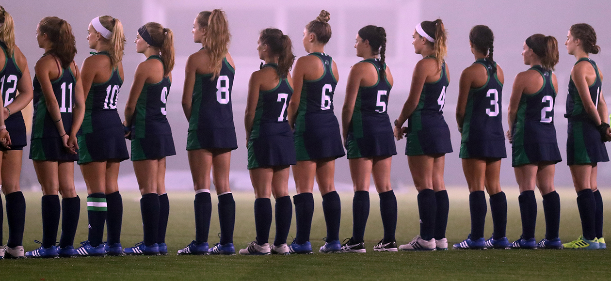 Endicott field hockey student-athletes stand for the national anthem.