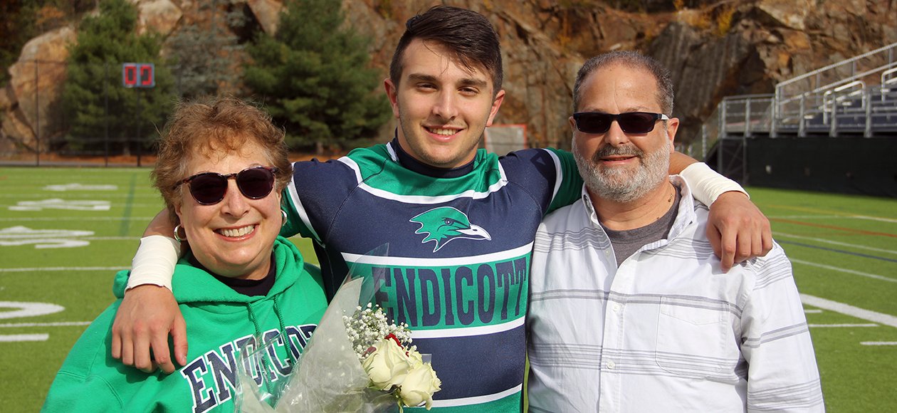 Jesse Adelberg poses with his family for a photo on senior day.