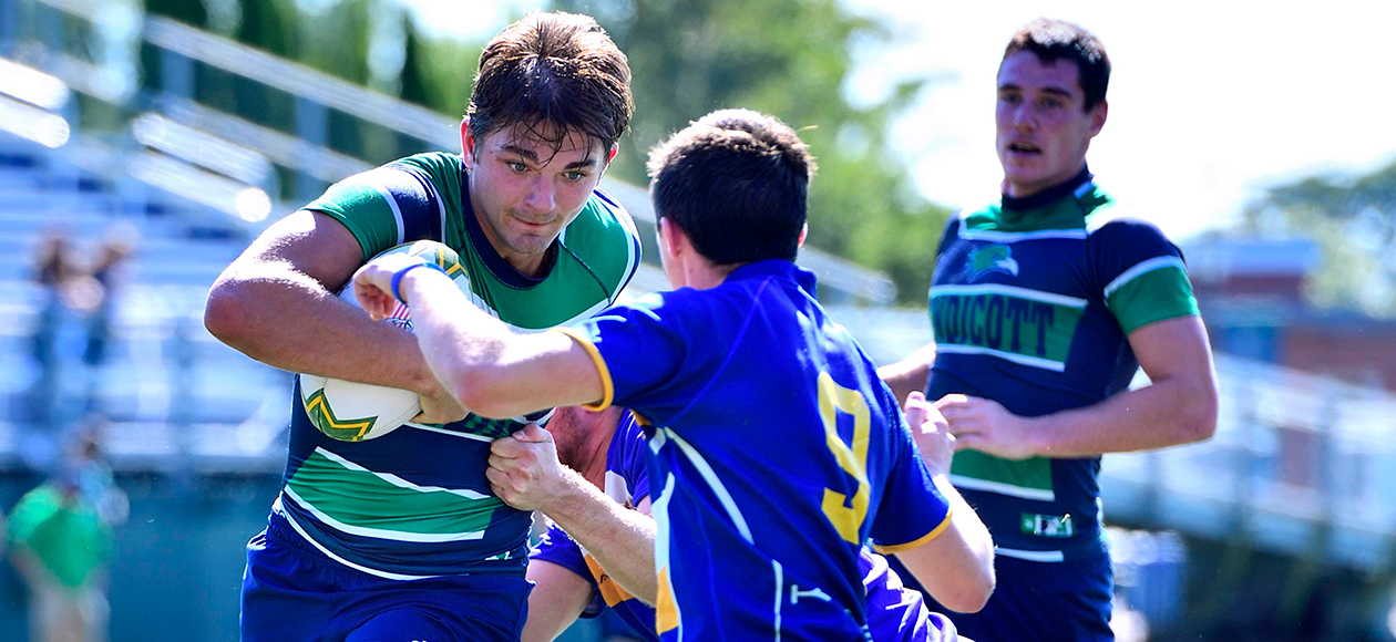 A men's rugby student-athlete avoids a tackle.