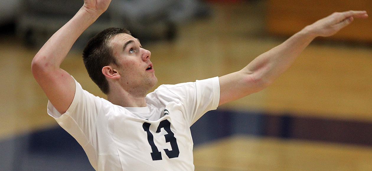 Ryan Sutherland swings at a volleyball.