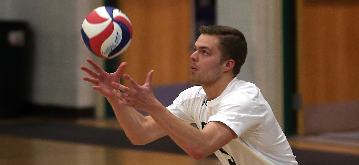 Tyler Willgoos throws a ball in the air before hitting it to serve to the opposing team.