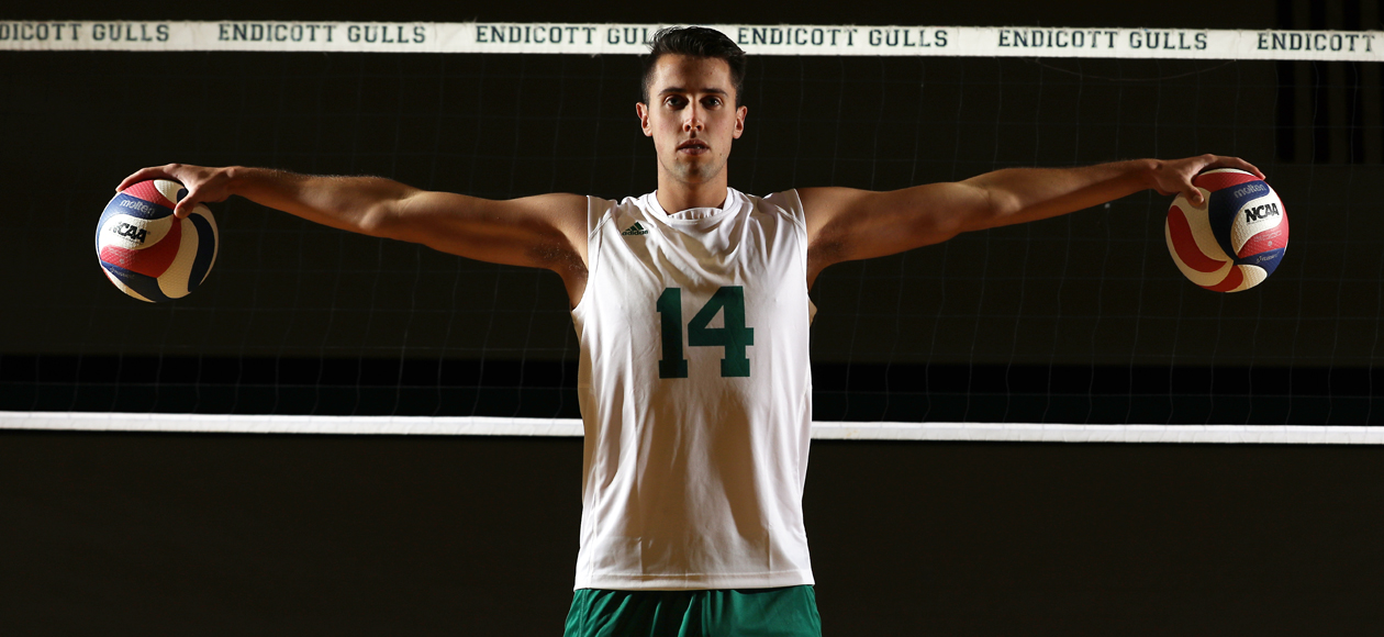 Posed photo of Jacob Newman holding two volleyballs.