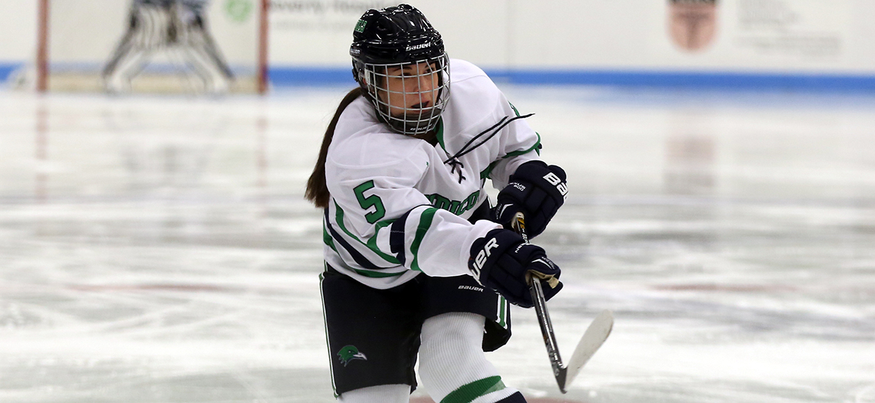 Madison Huber shoots a puck.