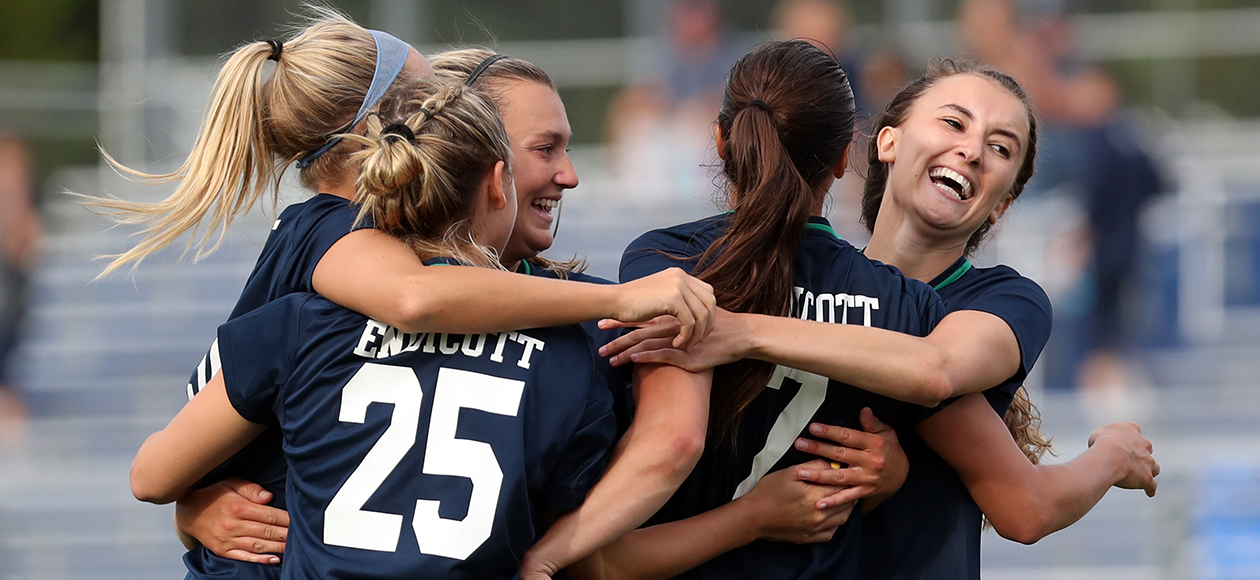 The Endicott women's soccer team celebrates a goal.