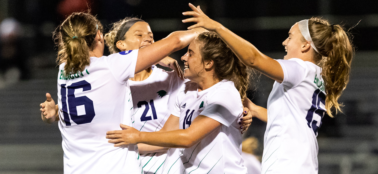 Four members of the Endicott women's soccer team celebrate after scoring a goal against Roger Williams.