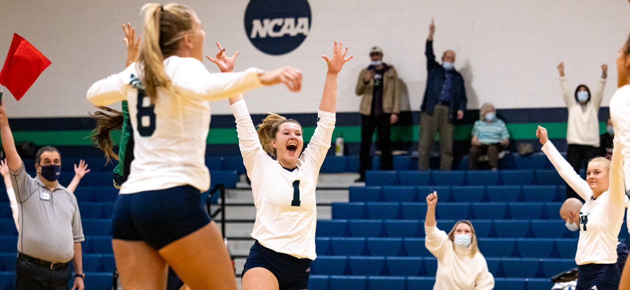 The women's volleyball team celebrates the final point of their 3-0 sweep over Salve Regina in the CCC semifinals.