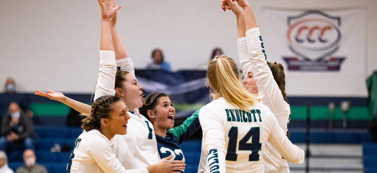 Members of the women's volleyball team celebrate a point by Colleen McAvoy.