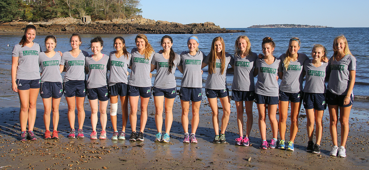The women's cross country team poses for a team photo on one of the beaches on campus.