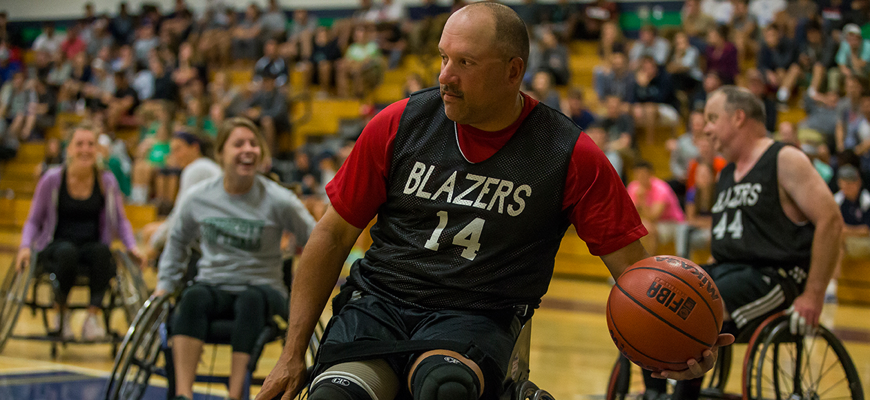 A member of the New England Blazers goes to pass a ball in a wheelchair.