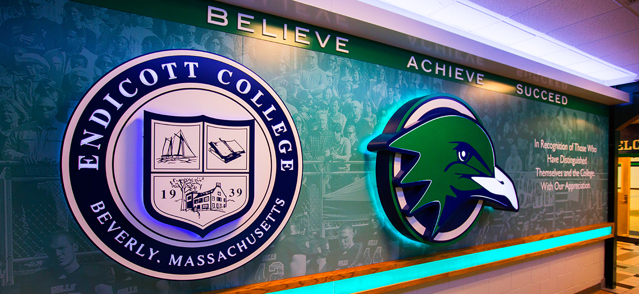 Photo of a wall with Endicott logos on it.