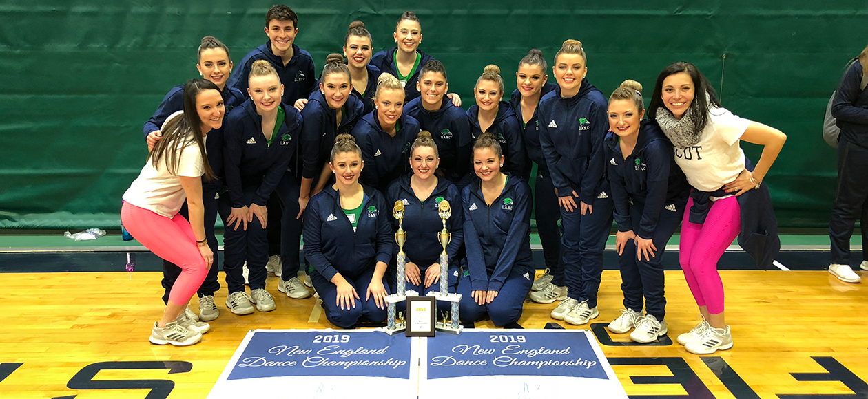 The dance team poses for a team photo with their trophies.