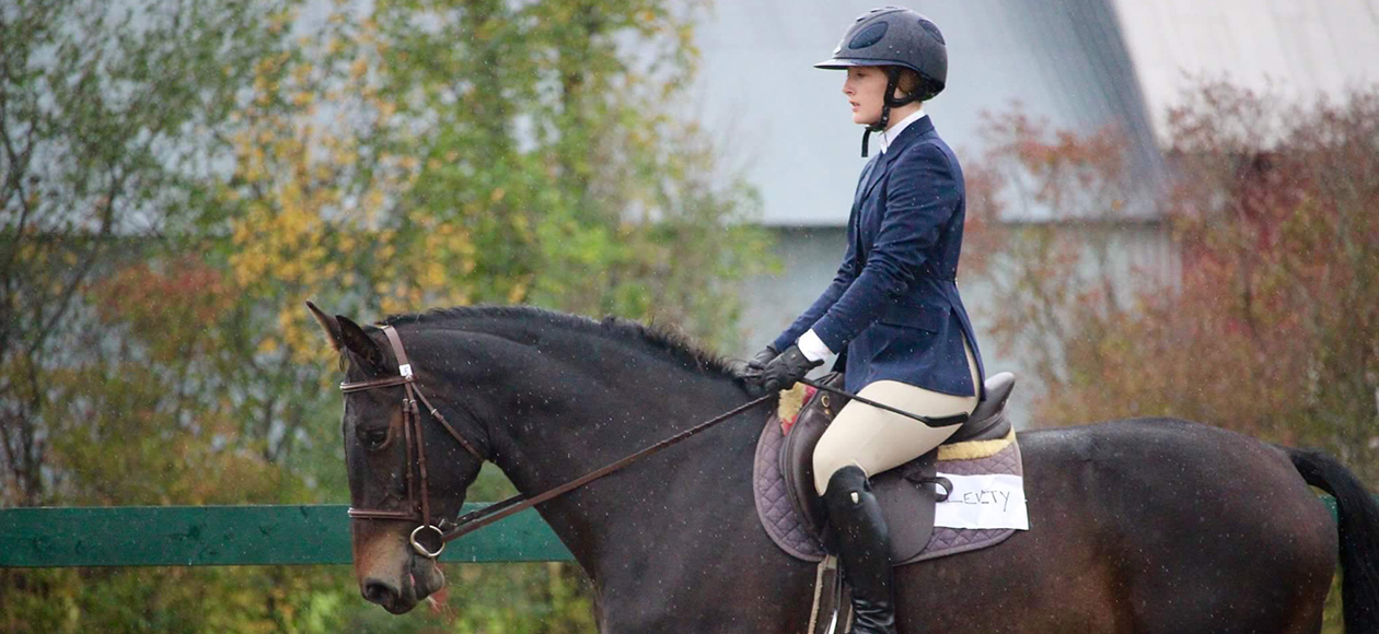 An equestrian student-athlete rides during a show.