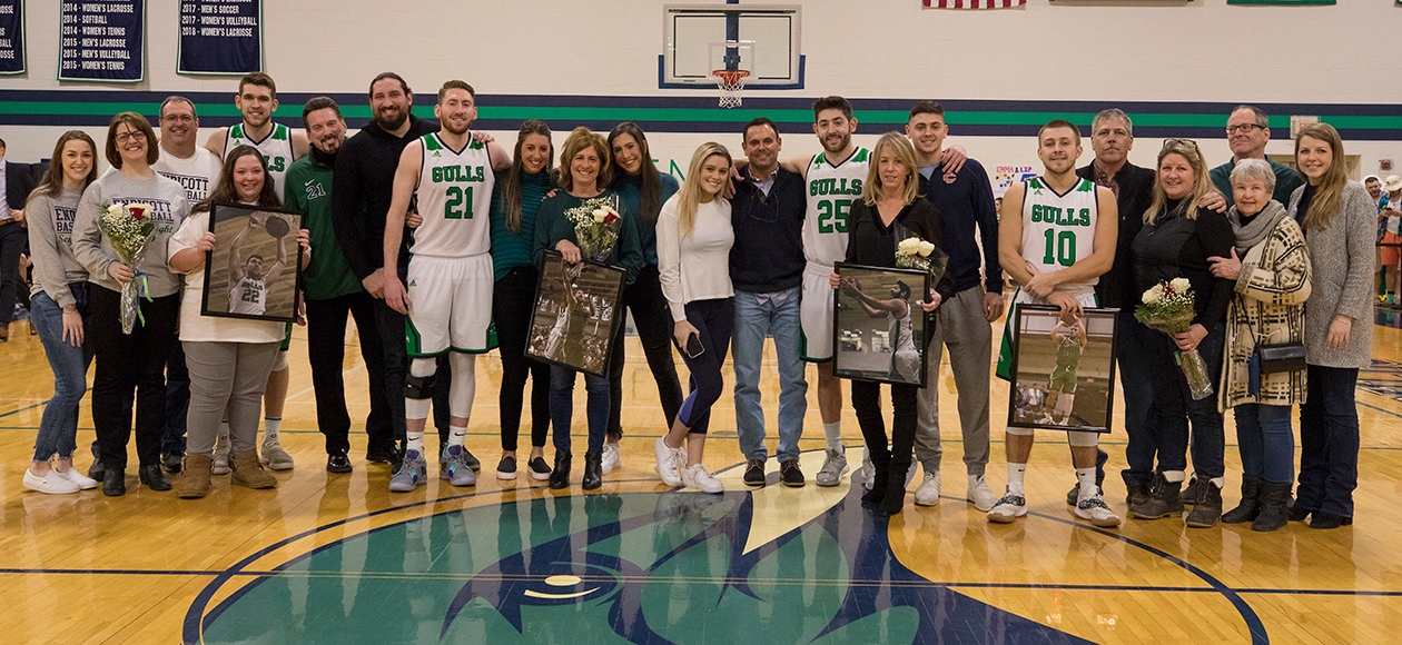 Families pose for a senior day photo.