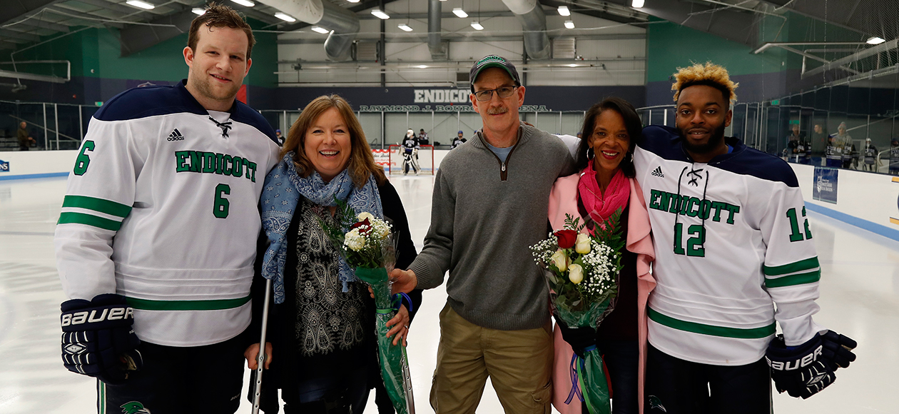 Seniors Connor Costello and Cameron Randles pose for a photo with their family members as a part of a pre-game Senior Day ceremony.