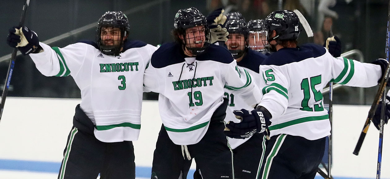 The Endicott men's ice hockey team celebrates Logan Day's game-winning goal.