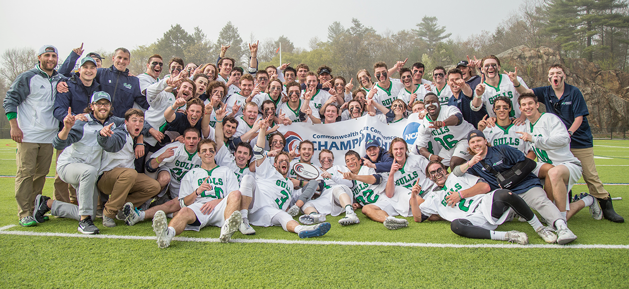 The Endicott men's lacrosse team huddles up for a team photo after winning the 2017 CCC Championship.