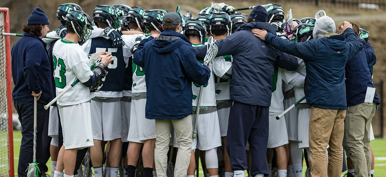 Men's lacrosse huddles up before a game.