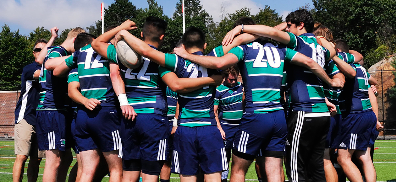 Men's rugby team huddles up.