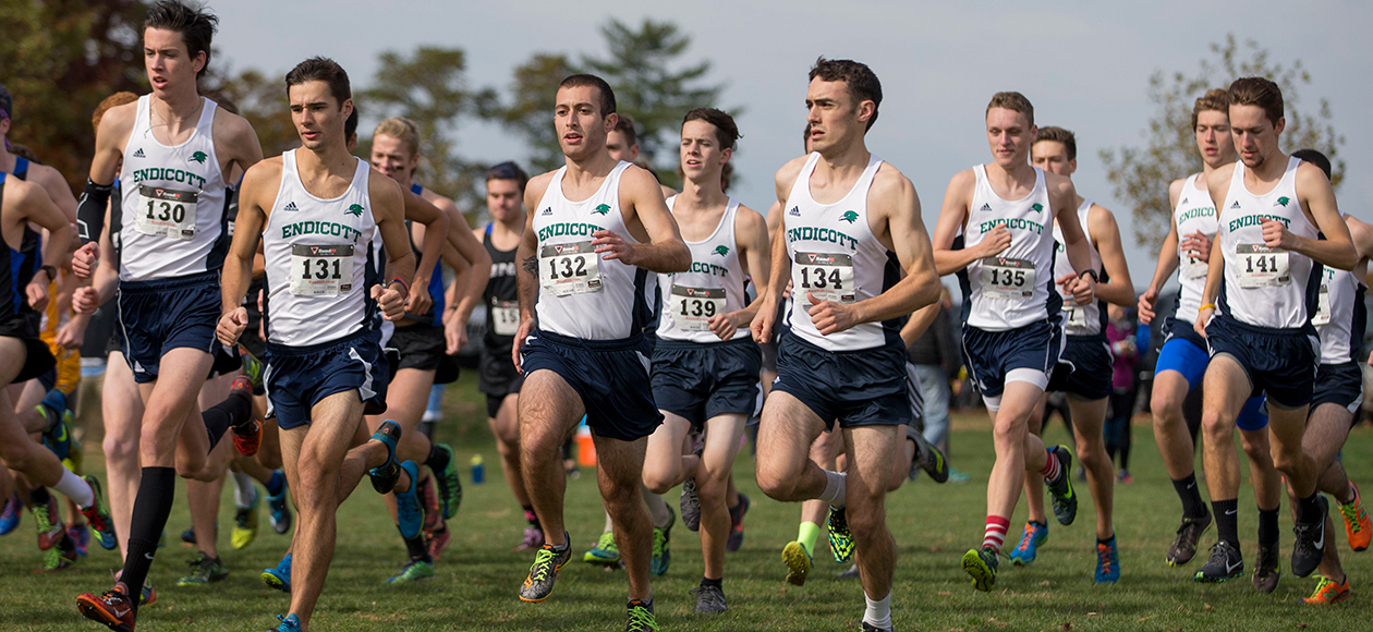 The men's cross country team runs at the start of the race.