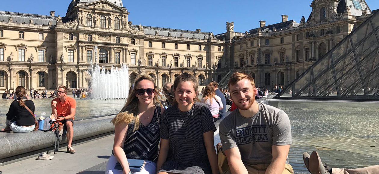 Holly Erbe takes a photo with friends in Europe.