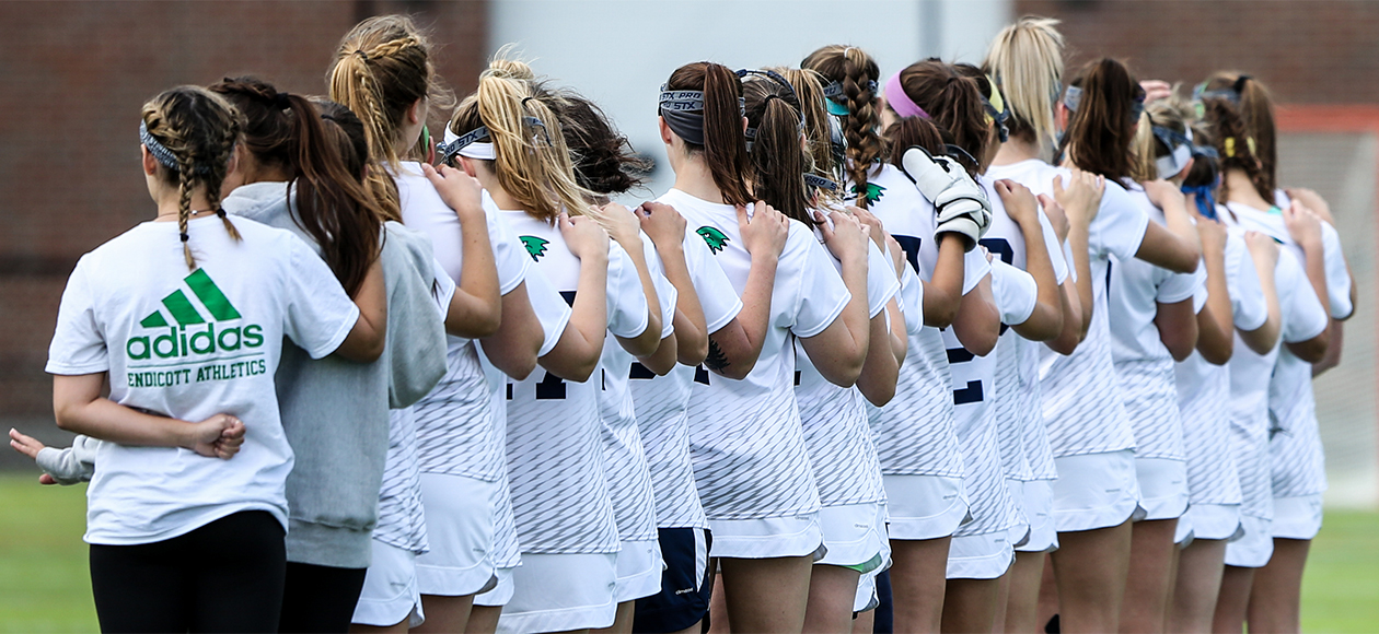 Endicott women's lacrosse team lines up for the National Anthem.