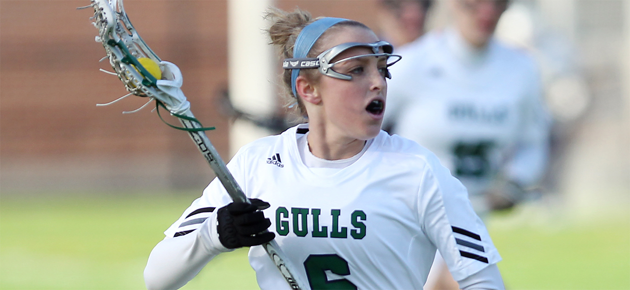 Meghan Lennon runs up the field cradling the ball in her stick.