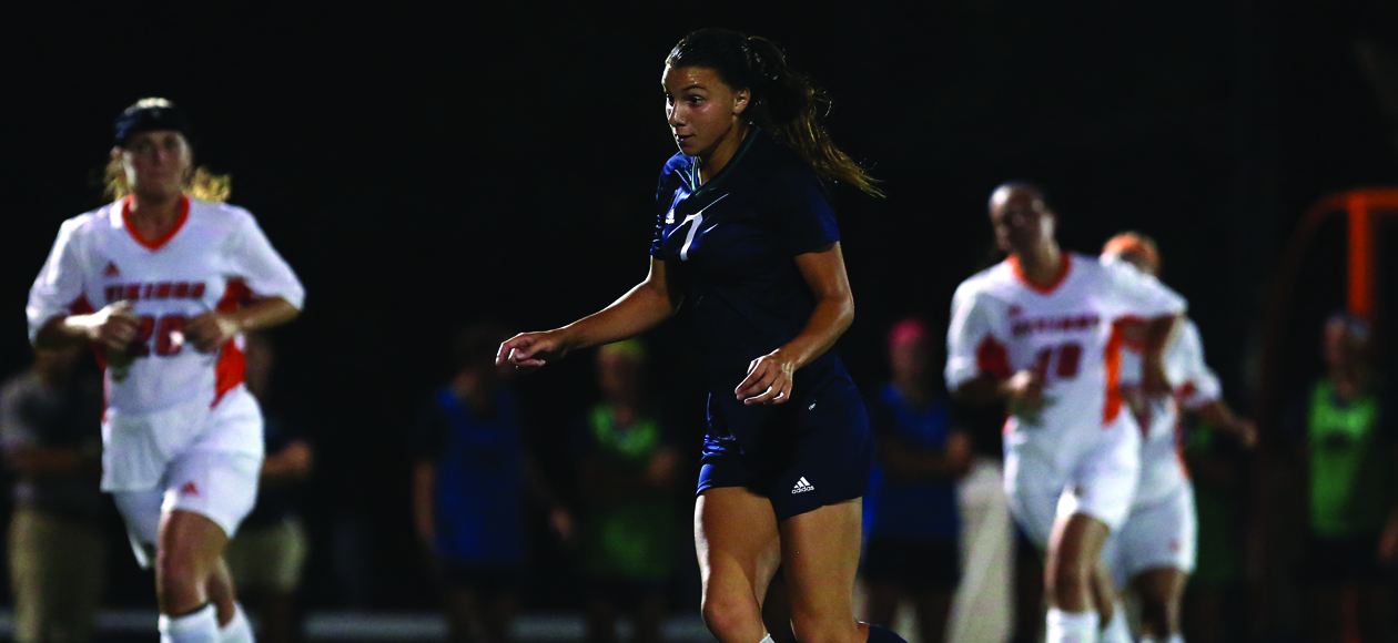 Image of Sharlotte Pernice dribbling upfield. 