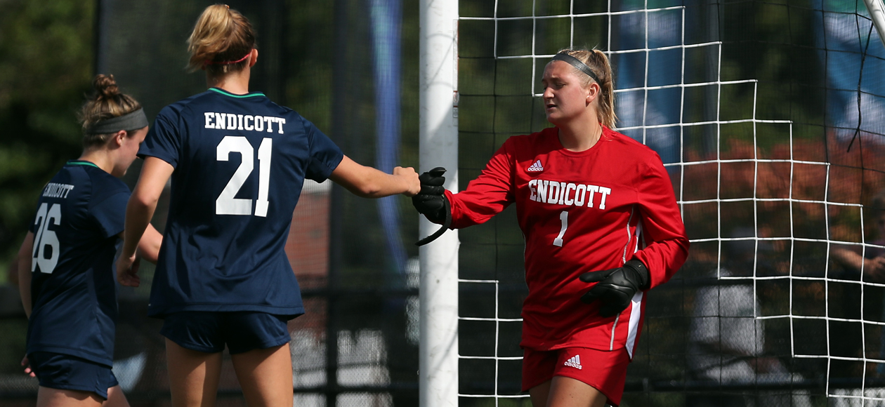 Keeper Kayla Wentworth and her defense fist bump after making a play.