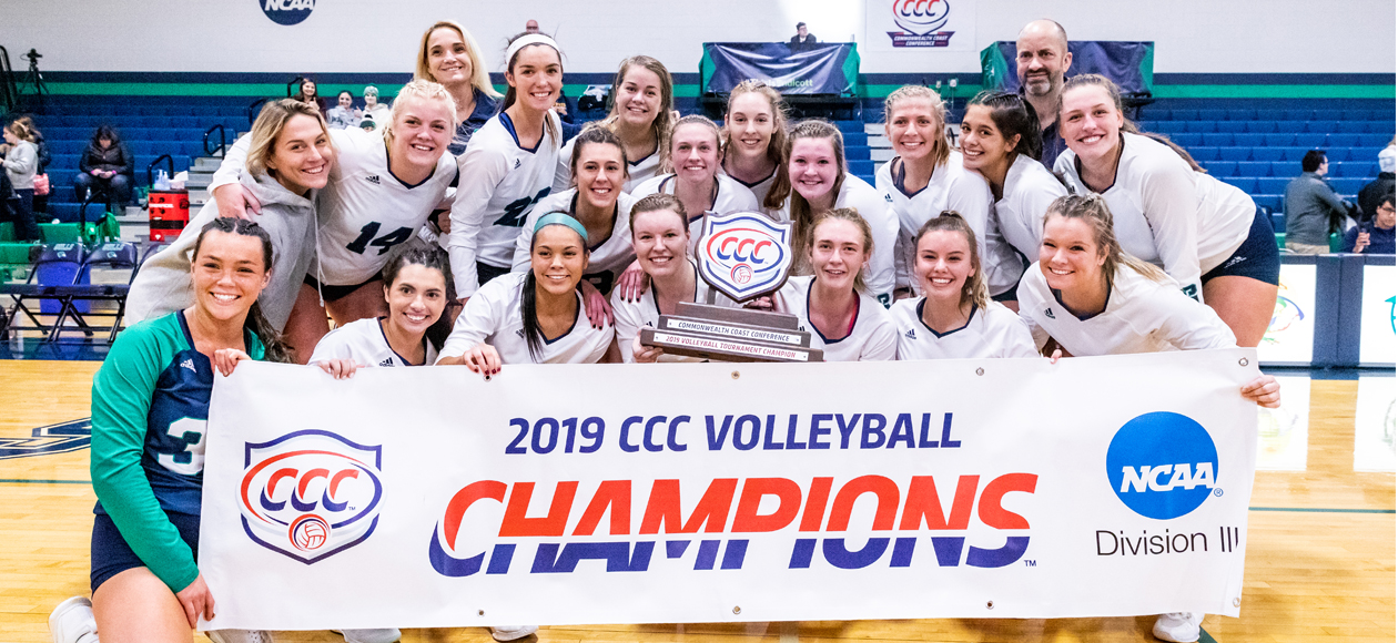 The Endicott women's volleyball team poses with the CCC trophy and banner. 