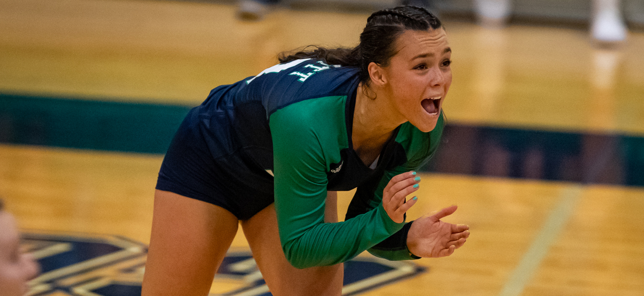 Image of libero Mackenzie Kennedy encouraging her teammates after a play. 