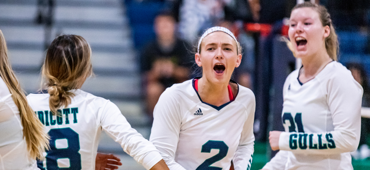 Image of Remi Quesnelle celebrating a kill with Lauren McGrath and Zoey Gifford.
