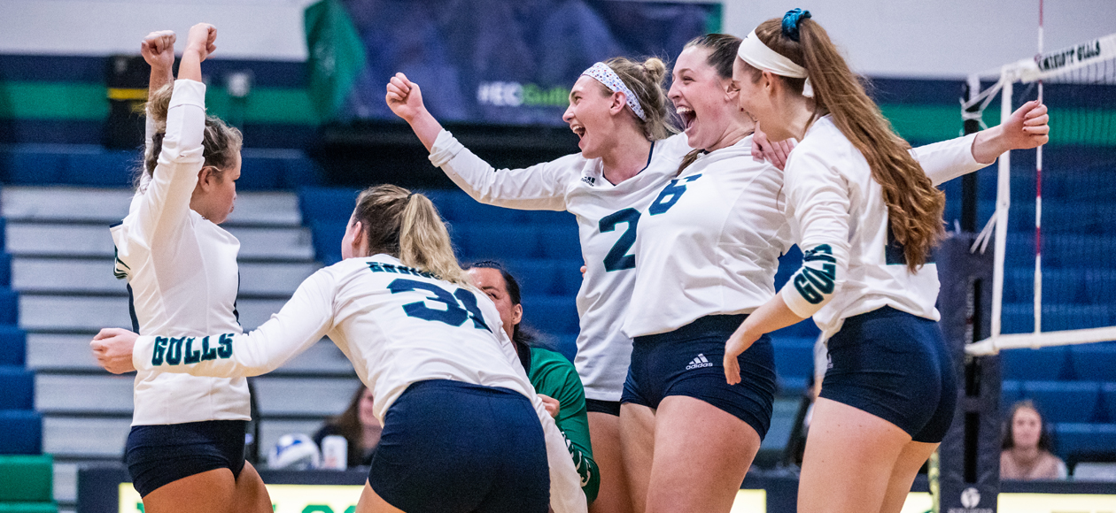 The women's volleyball team celebrates a point in the CCC Semifinal win over Salve Regina.