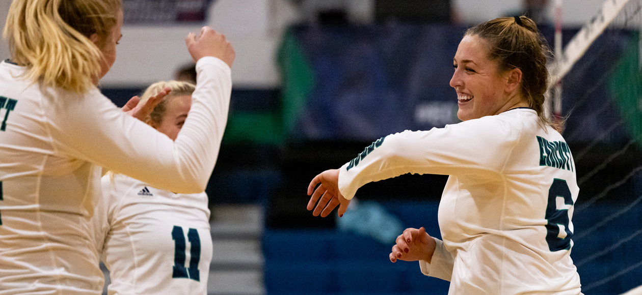 Colleen McAvoy celebrates a kill with her teammates.